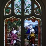 Stained glass window of Jesus at the well with Samaritan woman. Inscribed with In Memory of Mrs. Mary A. Turner.