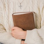 Woman holding bible.